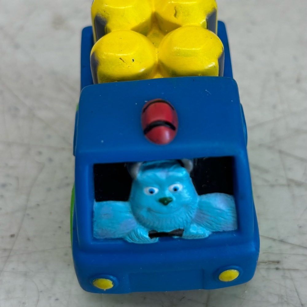 Pixar monsters Inc. Sully driving a blue car. 2 inches.